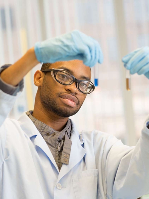 Student examining fluids in containers