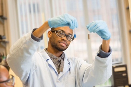 Student examining fluids in containers