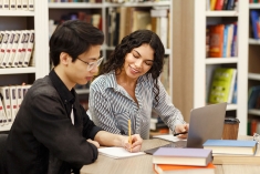 Two students studying in a library